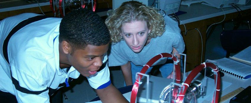 Two students working in physics lab.