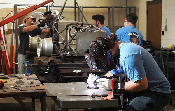 Nick Long, welding in the Science Laboratory Building at the University of South Alabama, is joined by other student members of South's chapter of the Society of Automotive Engineers last semester in building a hybrid vehicle to compete at the SAE Formula Hybrid Competition at the New Hampshire Motor Speedway.